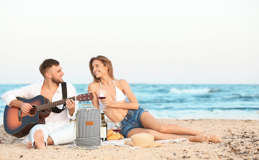 The best way for couples to have a romantic date at the beach - playing guitar and drinking wine